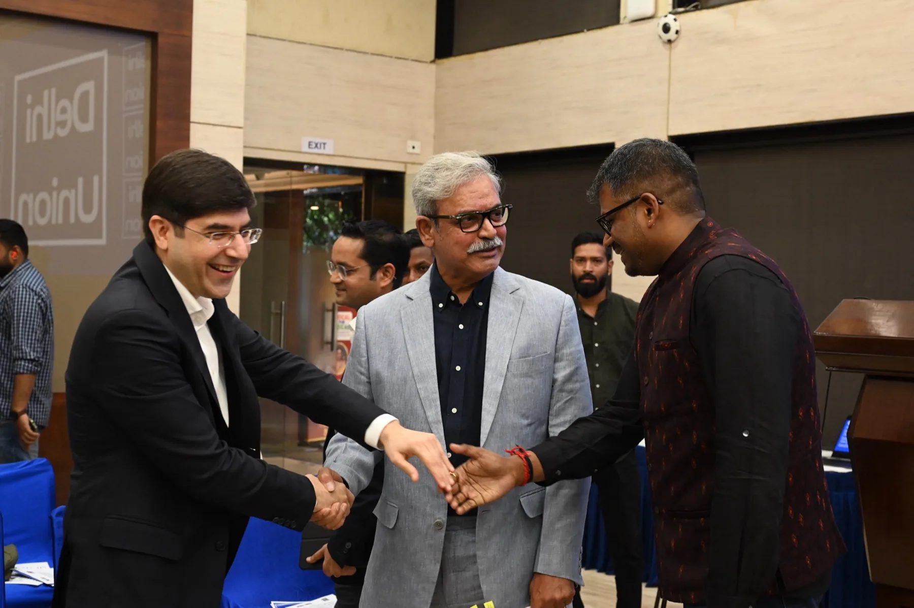 Members and speakers meeting on the floor after a sitting of the Delhi Union
